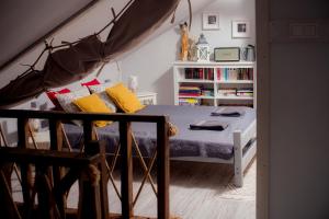 a bedroom with a bed and a book shelf at Dom Yarla in Janowiec