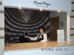 a woman is sitting in front of a mirror at Bilyj Rojal in Zaporozhye