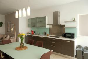 a kitchen with a table and a counter top at The 501 by Shmoo in Sliema