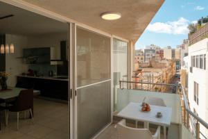 a balcony with a table and a view of a city at The 501 by Shmoo in Sliema