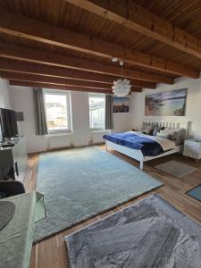 a large bedroom with a bed and a couch at Auszeit Tor zur Eifel in Euskirchen