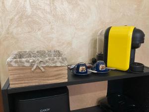 a shelf with a coffee maker and a box on it at Da Li Al Mar in Savona