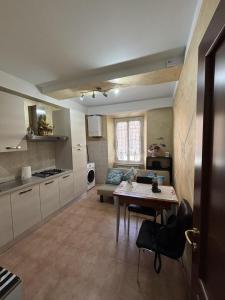 a kitchen with a table and a dining room at Da Li Al Mar in Savona
