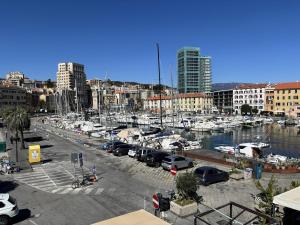 a marina with cars parked in a parking lot at Da Li Al Mar in Savona