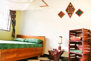 a bedroom with a wooden bed and a shelf at Rafiki Backpackers & Guesthouse in Moshi