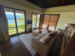a living room with a couch and a table at Villa Bukit Segara in Amed