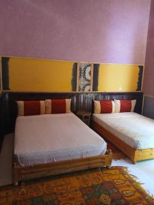 a room with two beds in a room at Chez Moulay Ismail in Agdz