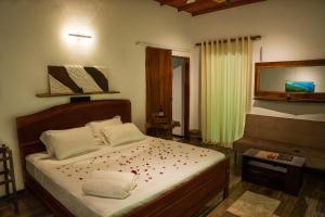 a bedroom with a bed with flowers on it at Zov Wild Yala in Kataragama