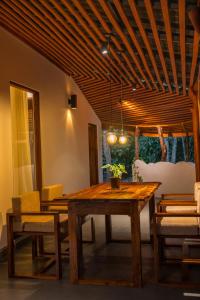 a dining room with a wooden table and chairs at Zov Wild Yala in Kataragama
