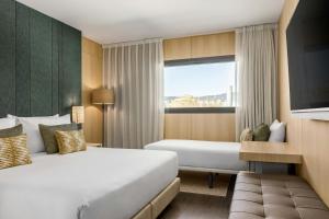 a hotel room with two beds and a window at AC Hotel Sants by Marriott in Barcelona