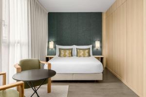 a bedroom with a bed and a table and a chair at AC Hotel Sants by Marriott in Barcelona