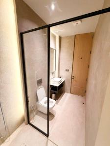 a bathroom with a toilet and a sink at Hotel The Unify in Jāmb +26 photos