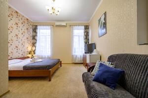 a hotel room with a bed and a couch at Hotel European 8 in Odesa