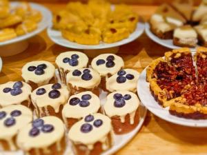 a table topped with plates of desserts and pies at 黑河易达酒店 in Heihe