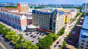 an aerial view of a city with cars parked in a parking lot at 黑河易达酒店 in Heihe