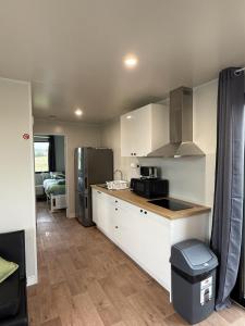 a kitchen with a counter top and a refrigerator at Peaceful Farm Retreat - Luxury Cabins in Goulburn in Norwood