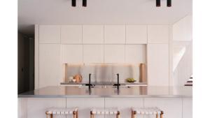 a kitchen with white cabinets and white counters at Architectual Design, Plunge Pool, Lagoon Frontage in Pearl Beach