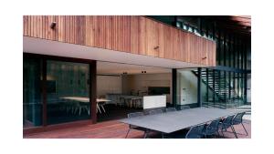 a house with a table and chairs on a deck at Architectual Design, Plunge Pool, Lagoon Frontage in Pearl Beach