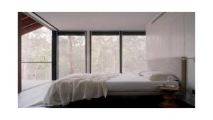 a bedroom with a bed and a large window at Architectual Design, Plunge Pool, Lagoon Frontage in Pearl Beach +16 photos
