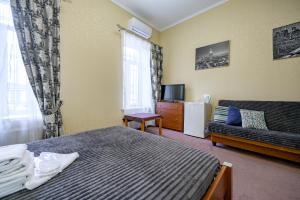 a hotel room with a bed and a couch at Hotel European 8 in Odesa