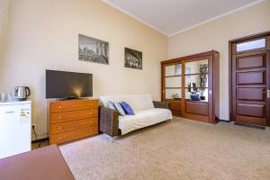 a living room with a couch and a flat screen tv at Hotel European 8 in Odesa +17 photos
