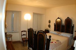 a bedroom with a bed and a lamp and a chair at Casa O in Pescaglia