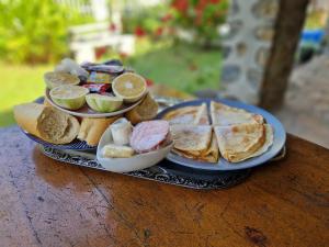 a plate of food with pancakes and other foods on a table at Cozy Beach Studio with Kitchen by Casa in Kribi