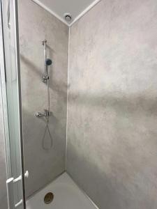 a bathroom with a shower with a glass door at Studio 2 Résidence Eugénie in Eaux-Bonnes