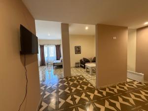 a living room with a television and a couch at Magic View Hotel in Goris