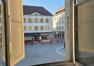 a view of a city street from a window at Studio lumineux in La Chaux-de-Fonds