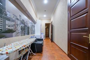 a waiting room with a table and a door at Hotel European 8 in Odesa