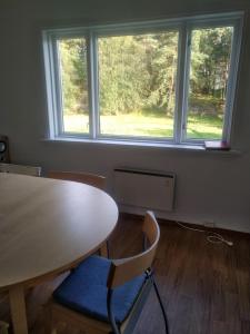 an empty room with a table and a window at Nernesholmen in Nes +13 photos