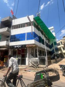 a man on a bike in front of a building at Hotel Golden Palace in Chhatarpur