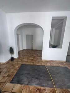 a living room with a large mirror and a rug at Ferienapartments Sternen WOHN 7 in Baiersbronn