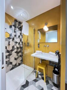 a bathroom with a sink and a shower at Maison d'Hôtes Bastia in Bastia