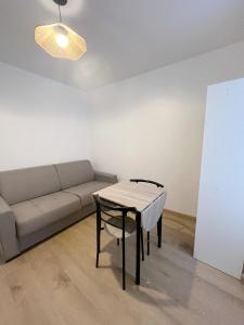 a living room with a couch and a table at Studio 2 Résidence Eugénie in Eaux-Bonnes