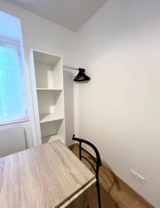 a room with a wooden table and a shelf at Studio 2 Résidence Eugénie in Eaux-Bonnes
