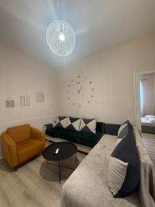 a living room with a couch and a chair at Limore Hostel in Tirana
