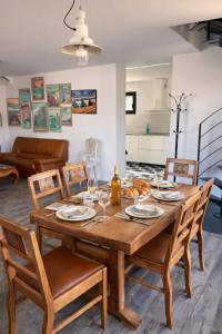 a dining room with a wooden table and chairs at Maison classée à 100m de l'océan in Mimizan-Plage