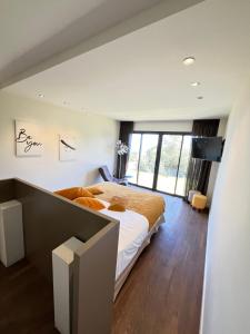 a bedroom with a large bed and a flat screen tv at Maison d'Hôtes Bastia in Bastia