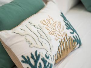 a pillow with a pattern on it sitting on a bed at Syrene Suites Sorrento in Piano di Sorrento