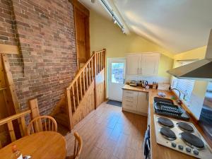a kitchen with a table and a stove top oven at The Signal Box at Cliburn Station in Penrith