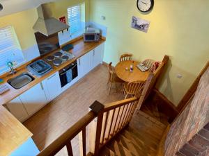 an overhead view of a kitchen with a wooden table at The Signal Box at Cliburn Station in Penrith +3 photos