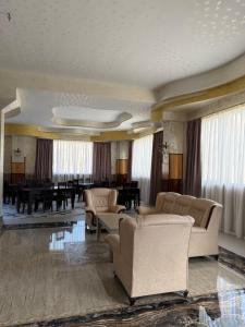 a living room with couches and a dining room at Magic View Hotel in Goris
