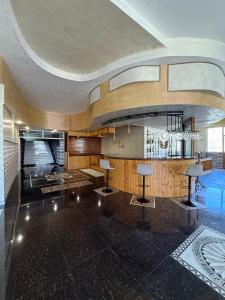 a lobby with two tables and a chandelier at Magic View Hotel in Goris