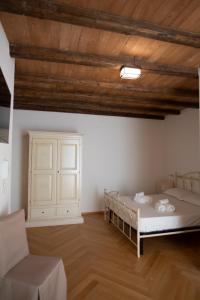 a room with two bunk beds and a chair at Suite San Gaetano in Conversano