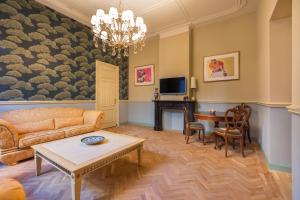 a living room with a couch and a table at The Royal Suite II - R.Q.C. in The Hague