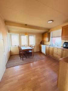 a kitchen with a table and a dining room at Large apartment with parking in Sandefjord