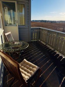 a patio with a table and chairs on a balcony at Large apartment with parking in Sandefjord