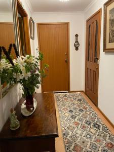 a hallway with a vase of flowers on a table at Bluff House in Saint Leonards